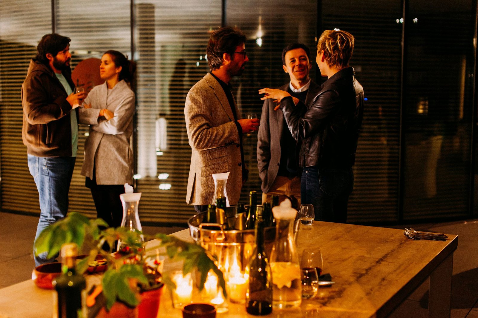 Guests chatting around a candlelit table at a networking evening