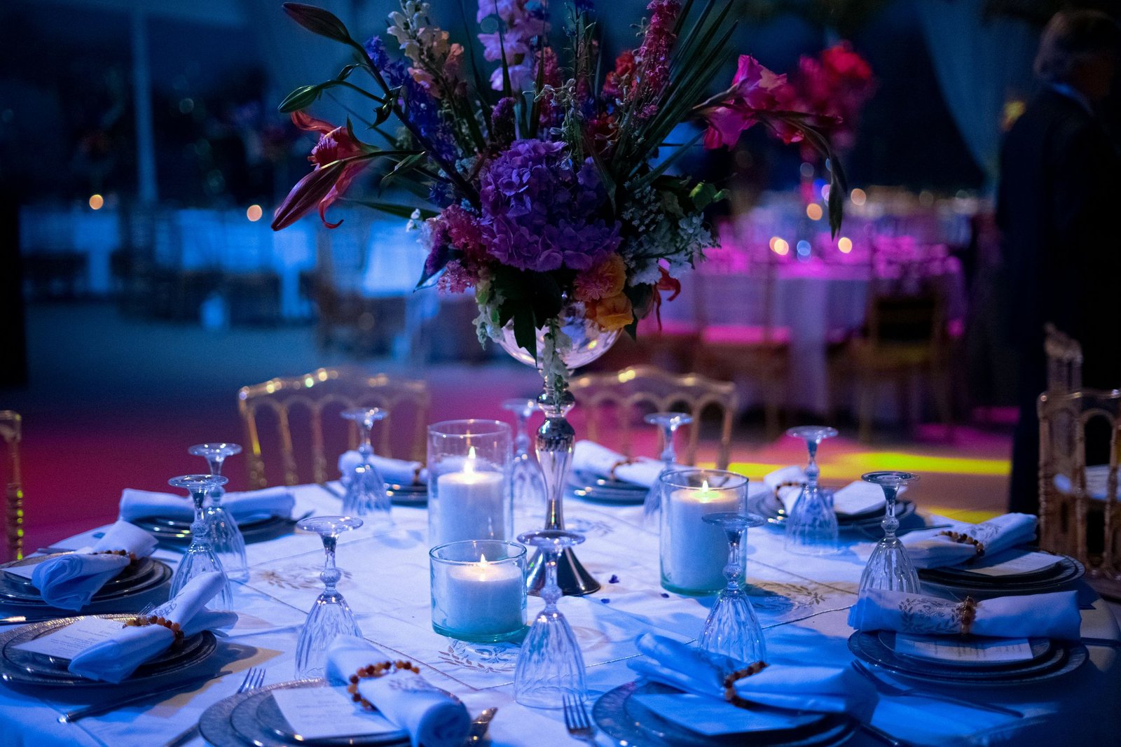 An elegant dinner table with flowers, candles and glassware